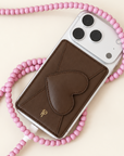 Brown Heart Leather Magnetic Phone Wallet on white iPhone with pink beaded phone strap