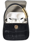 Open black croc purse charm with AirPods Pro earbuds visible