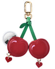 Cherry leather bag charm shown with AirTag inserted, Posh Tech glossy red leather design