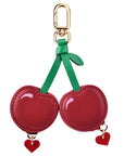 Back view of Cherry leather AirTag bag charm with heart-shaped zipper pulls by Posh Tech