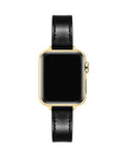 Apple Watch with Black patent leather band, top-down view showing gold case and black face