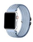 Aura Blue braided nylon loop Apple Watch band worn on wrist, angled view showing adjustable buckle