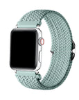 Sage Green braided nylon loop Apple Watch band worn on wrist, angled view showing adjustable buckle