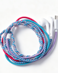 A braided multi-colored charging cable with white earbud-style connectors, coiled on a clean white background.