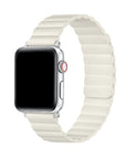 A smartwatch with a black screen and an ivory segmented silicone band, shown on a plain white background.