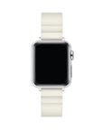 A silver smartwatch with a rectangular black screen and an ivory-colored silicone strap, shown against a plain white background.
