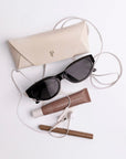 Josie Cateye Smart Sunglasses shown with protective case, cleaning cloth, and charging cable
