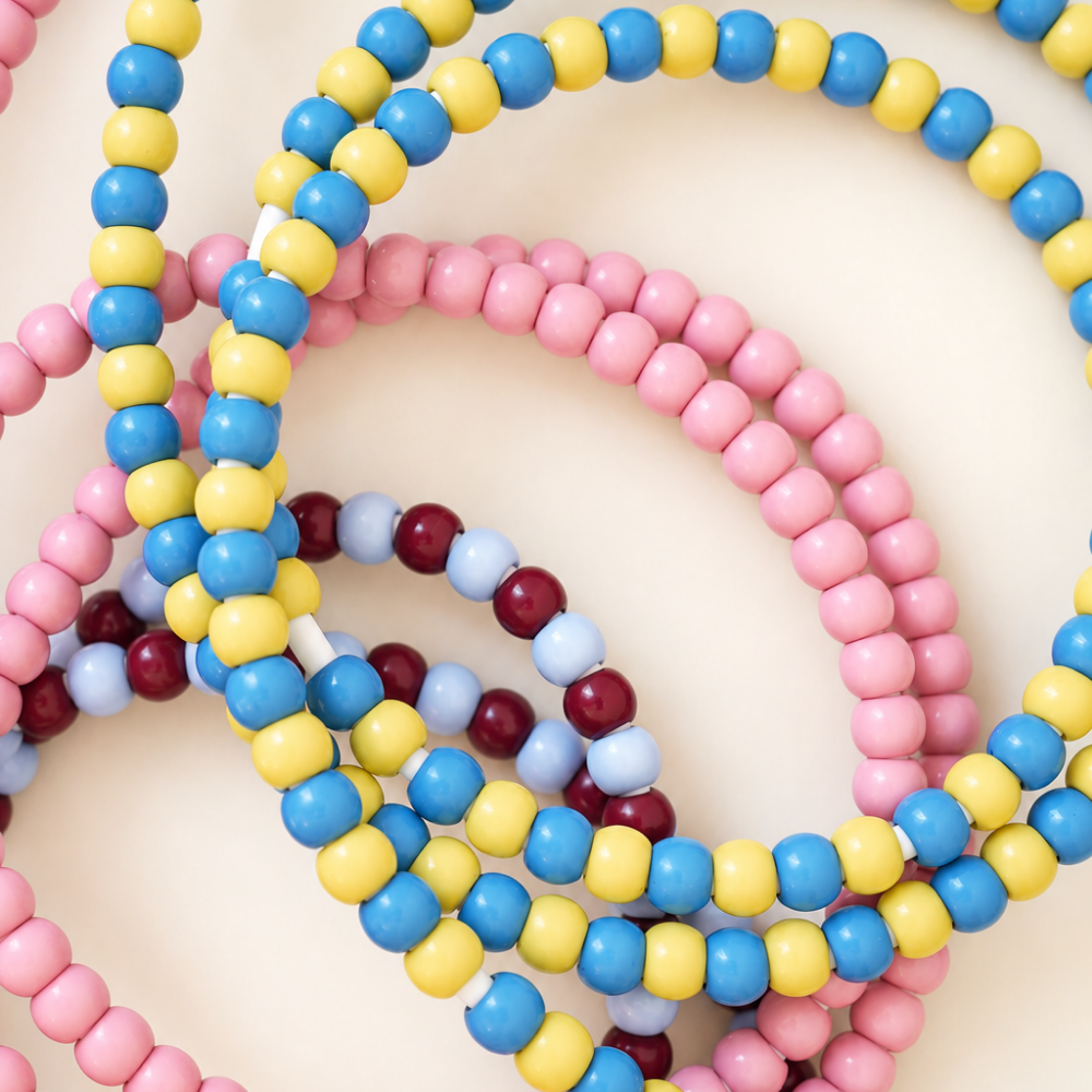Pile of pink, blue and yellow, and burgundy and light blue USB-C beaded charging cables