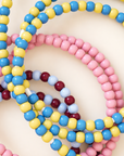 Pile of pink, blue and yellow, and burgundy and light blue USB-C beaded charging cables