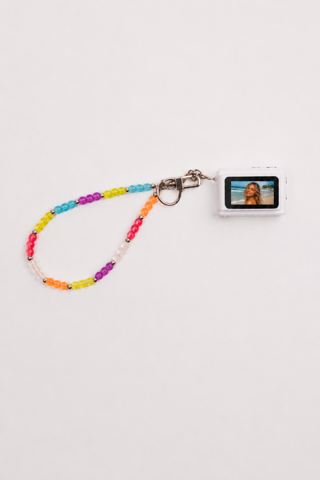 Mini digital camera with rainbow beaded lanyard showing photo on screen