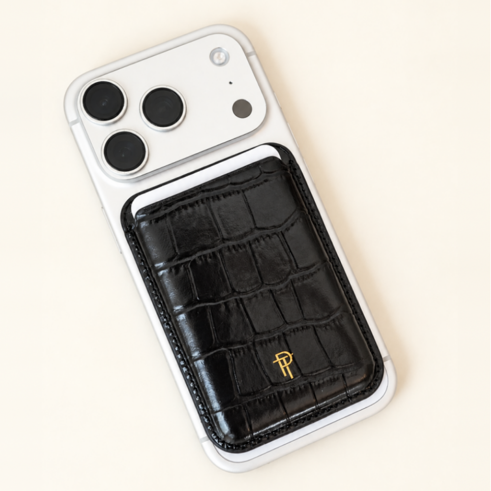 Black Croc Leather Magnetic Phone Wallet with gold logo attached to back of white iPhone