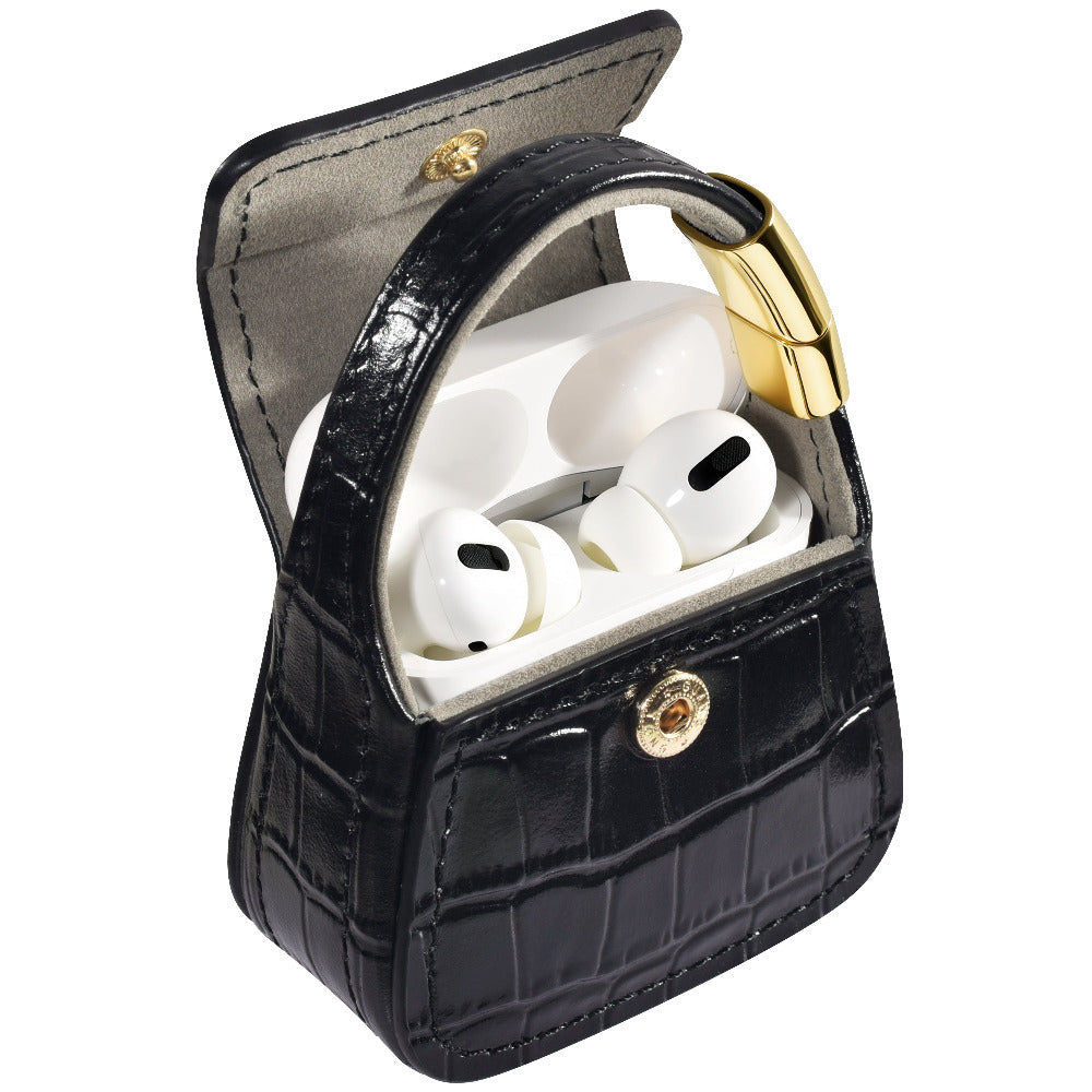 Open black croc purse charm showing AirPods Pro case inside