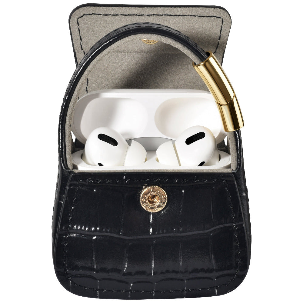 Open black croc purse charm with AirPods Pro earbuds visible