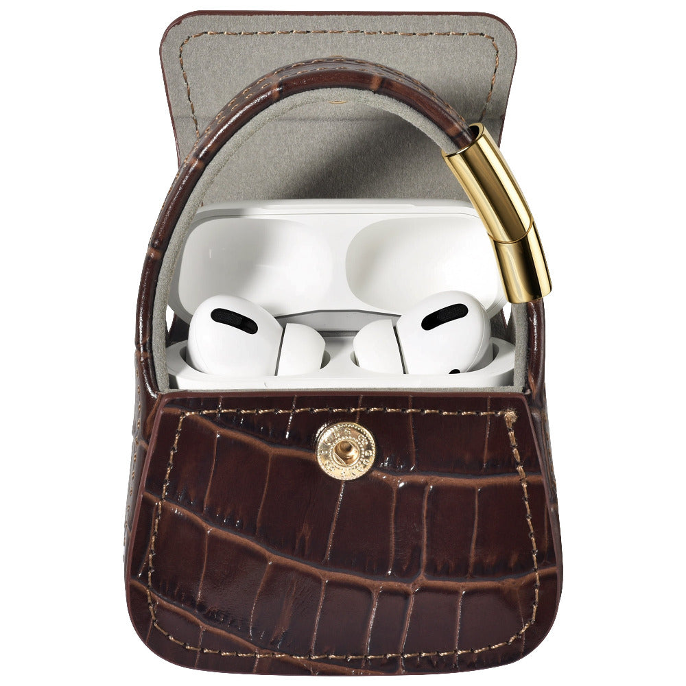 Open brown croc purse charm with AirPods Pro earbuds visible