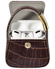 Open brown croc purse charm with AirPods Pro earbuds visible