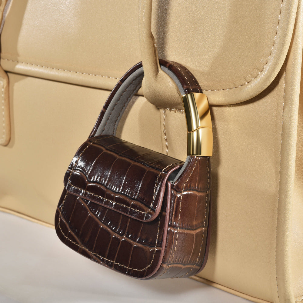 Brown croc mini purse AirPods case clipped closed, back view