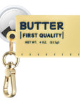 Posh Tech yellow Butter silicone AirTag bag charm shown with AirTag inserted, First Quality print