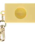 Back view of Butter silicone AirTag bag charm with cutout opening by Posh Tech