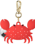 Posh Tech red silicone crab AirTag bag charm shown with AirTag inserted, polka dot detail