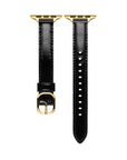 Black patent leather Apple Watch band laid flat, showing stitching and adjustable holes