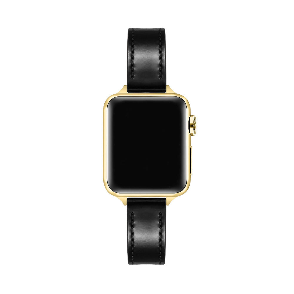 Apple Watch with Black patent leather band, top-down view showing gold case and black face
