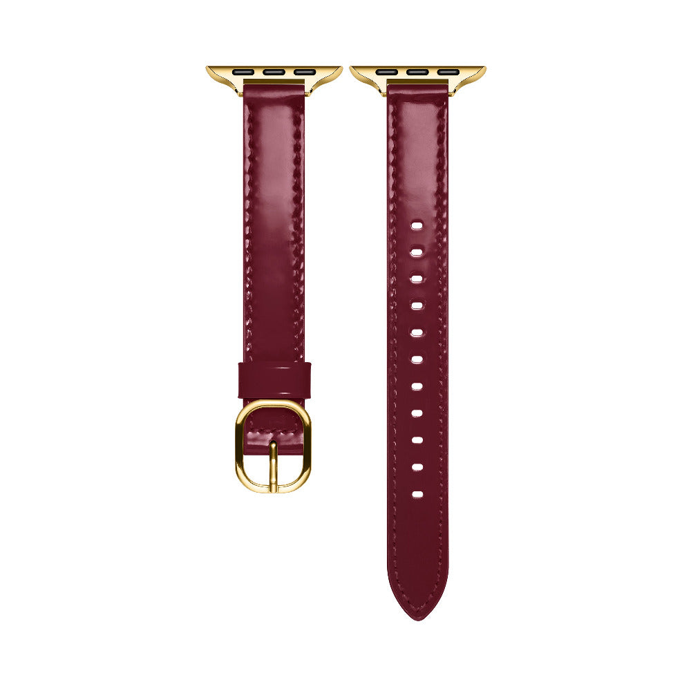 Cherry Lacquer patent leather Apple Watch band laid flat, showing stitching and adjustable holes