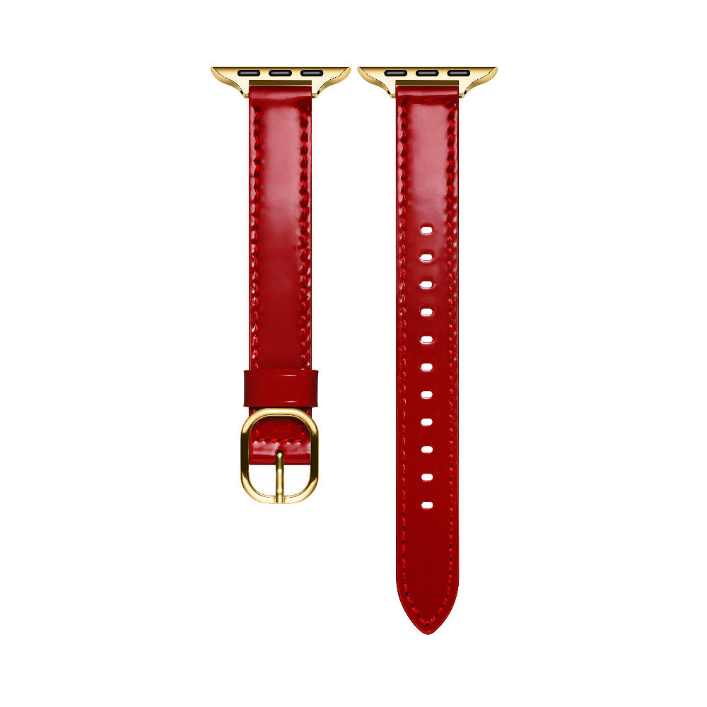 Crimson patent leather Apple Watch band laid flat, showing stitching and adjustable holes