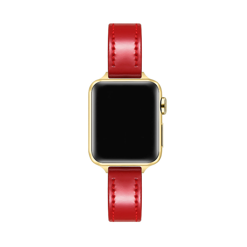 Apple Watch with Crimson patent leather band, top-down view showing gold case and black face
