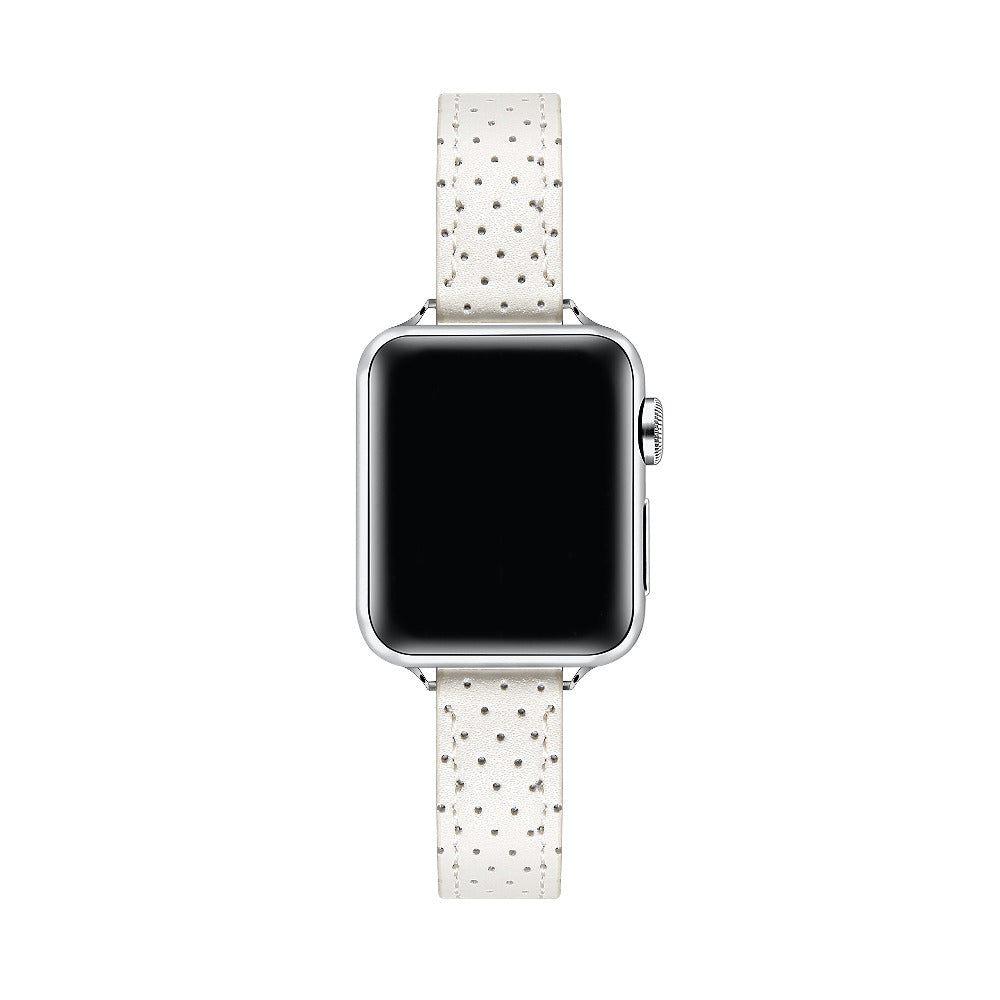 Apple Watch with Ivory perforated leather band, top-down view showing silver case and white face