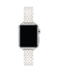 Apple Watch with Ivory perforated leather band, top-down view showing silver case and white face