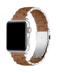 A silver stainless steel smartwatch band with a brown leather inner lining, shown attached to a silver smartwatch on a clean white background.