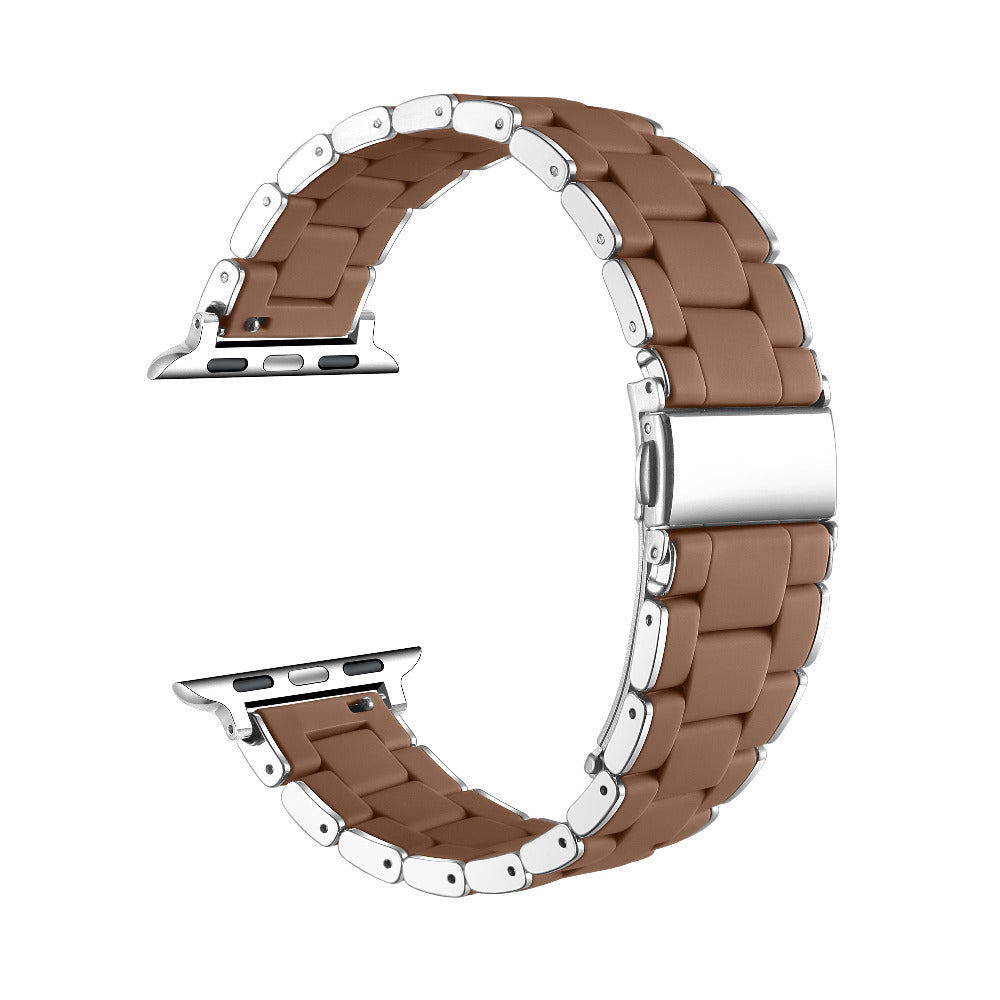 A curved stainless steel link watch band with a warm brown silicone inner lining, displayed on a clean white background.