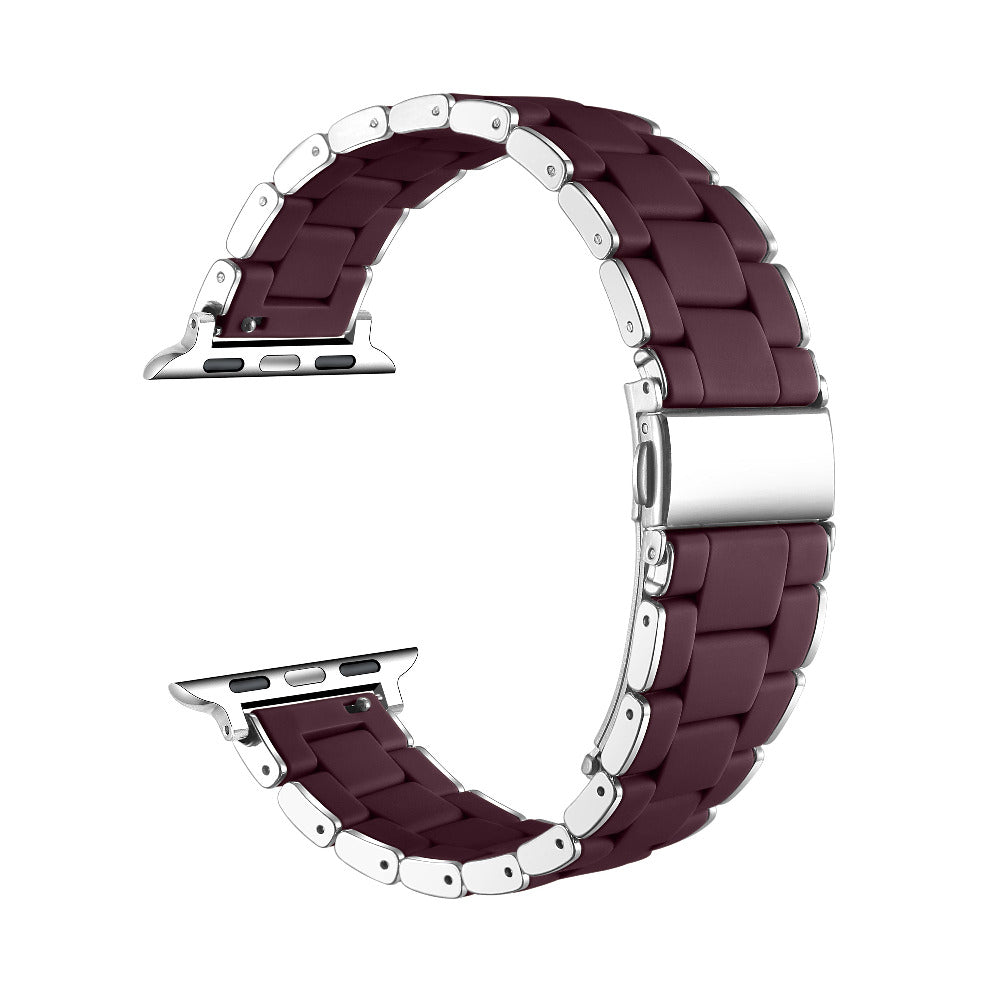 A dark burgundy silicone watch band with silver-toned metal connector pins and clasp, shown in a curved loop shape on a plain white background.