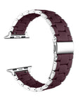 A dark burgundy silicone watch band with silver-toned metal connector pins and clasp, shown in a curved loop shape on a plain white background.
