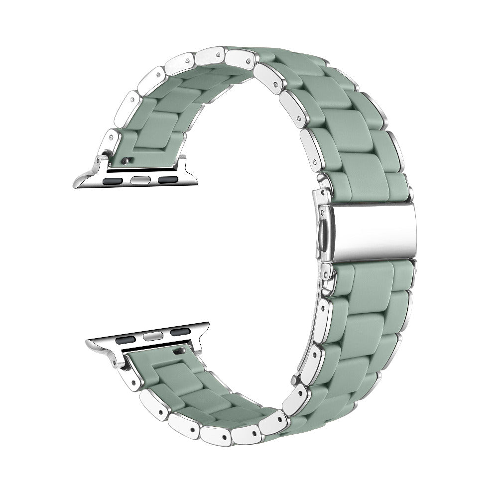 A mint green silicone watch band with silver stainless steel links and hardware, shown in a curved loop shape on a plain white background.
