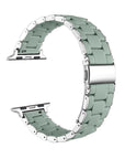 A mint green silicone watch band with silver stainless steel links and hardware, shown in a curved loop shape on a plain white background.