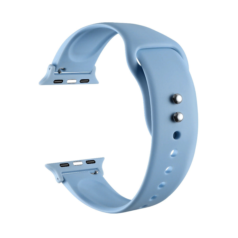 Ice blue silicone Apple Watch® band unclasped, flat-lay view showing pin-and-tuck closure and size adapters