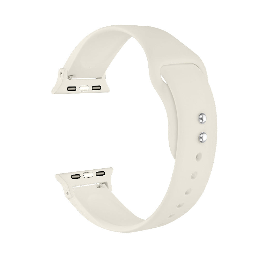 Ivory silicone Apple Watch® band unclasped, flat-lay view showing pin-and-tuck closure and size adapters