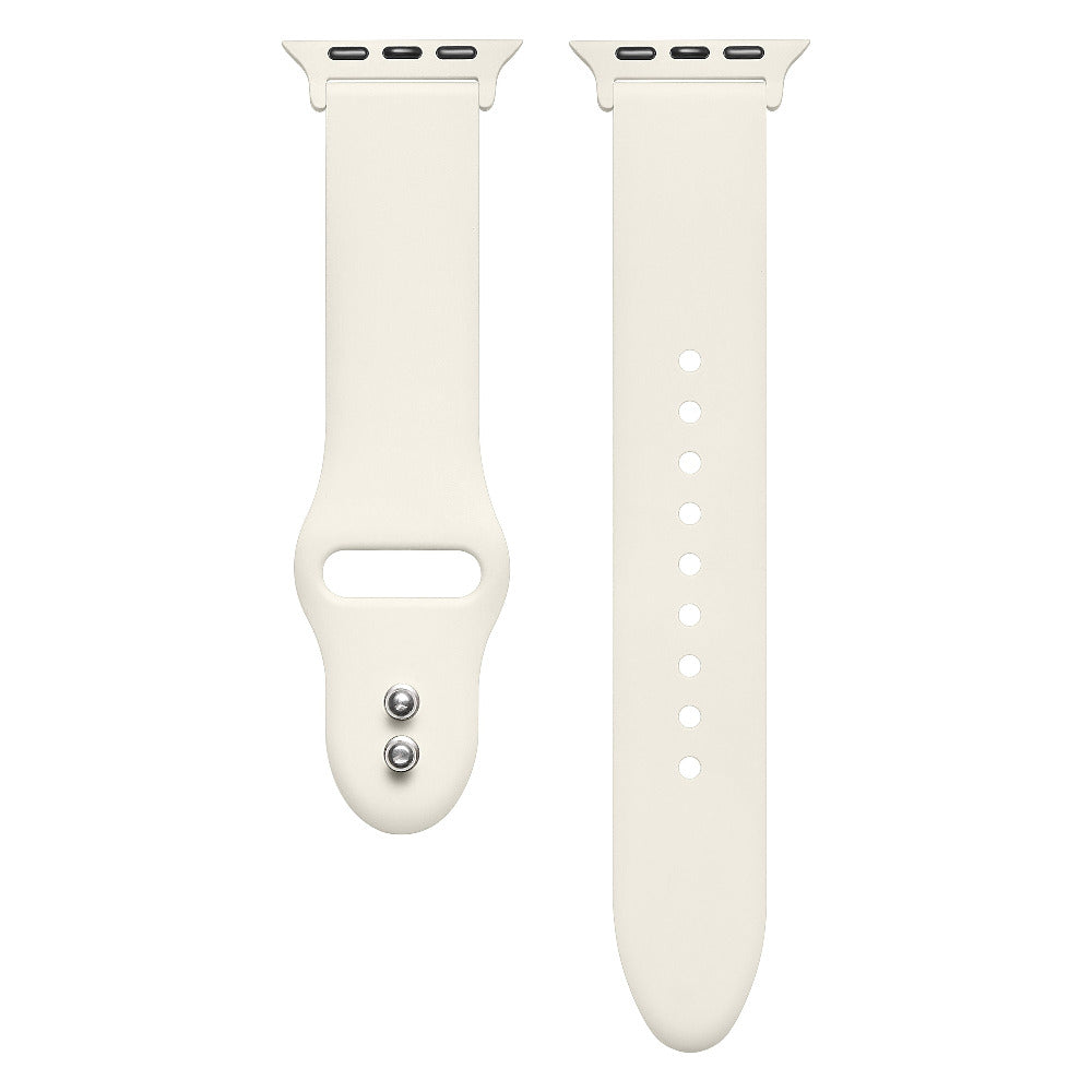 Ivory silicone Apple Watch® band close-up, detail view of molded texture and pin closure holes