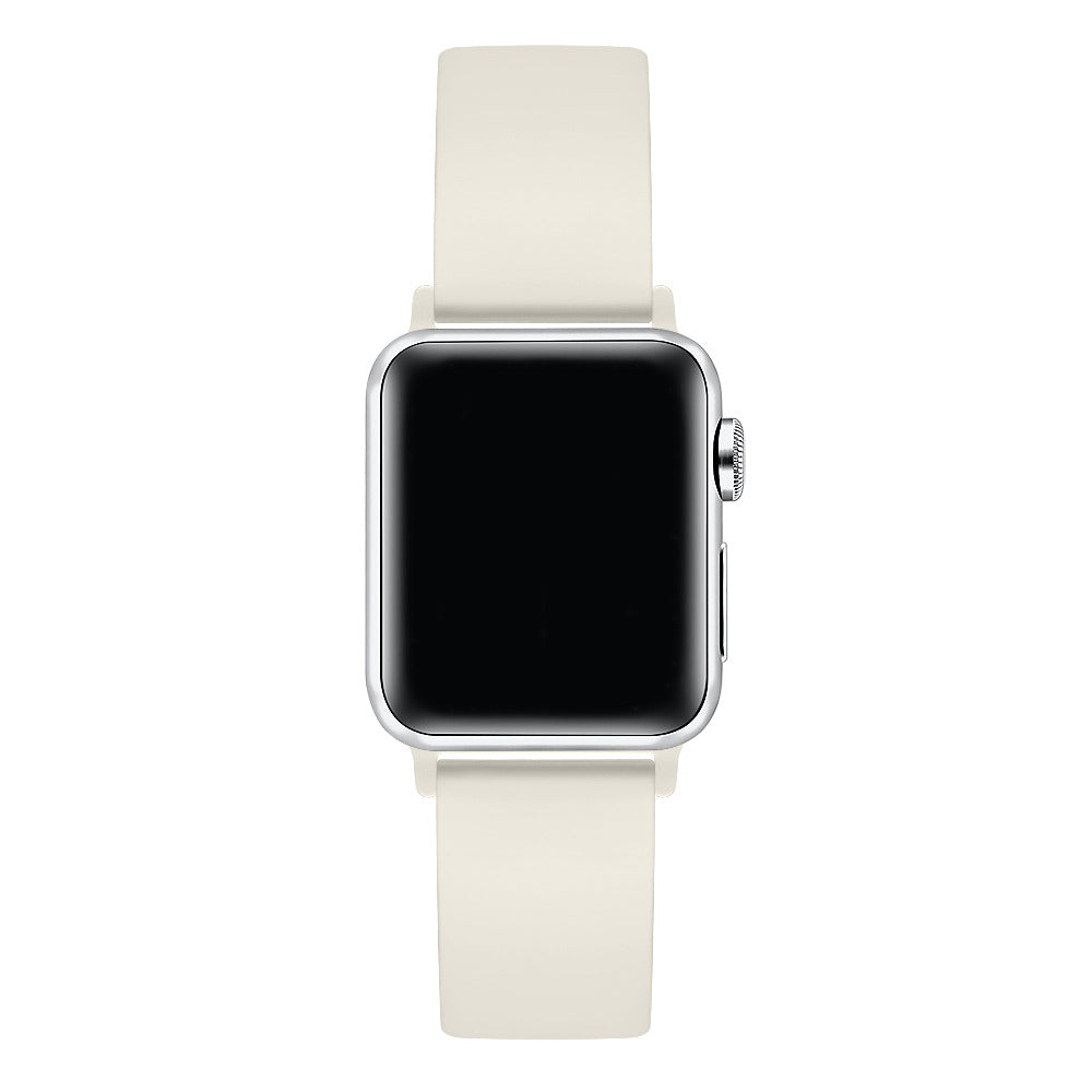 Ivory silicone Apple Watch® band fastened on the watch case, angled side view showing pin-and-tuck closure