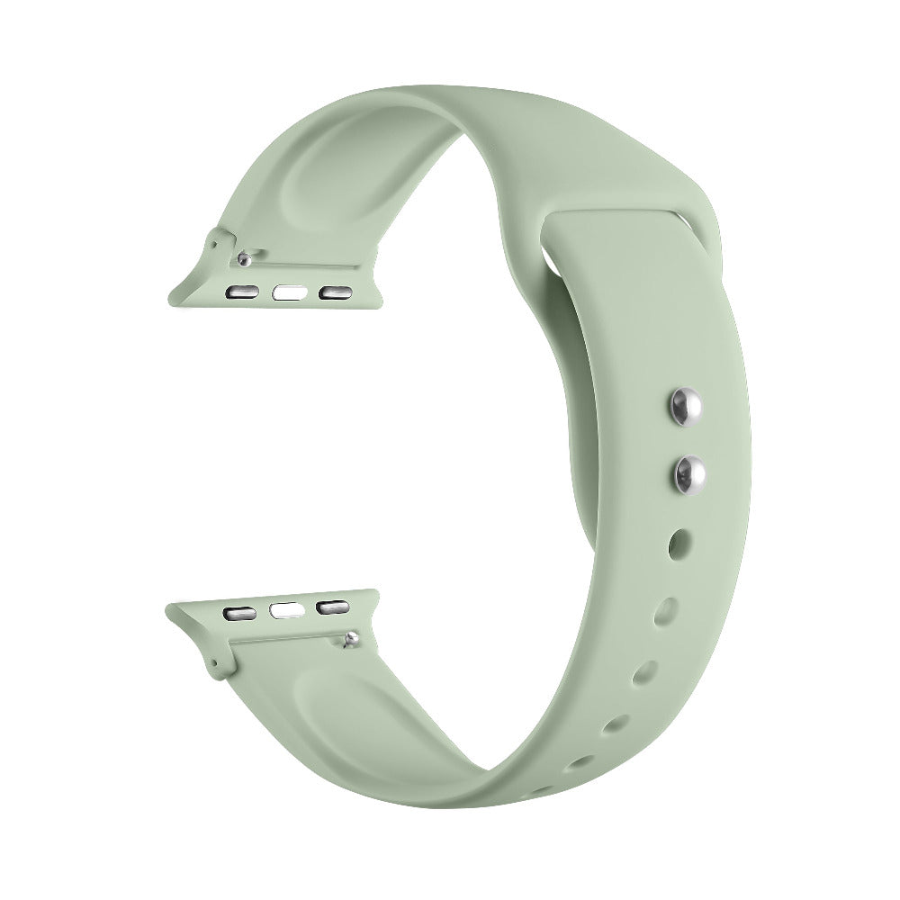 Sage green silicone Apple Watch® band unclasped, flat-lay view showing pin-and-tuck closure and size adapters