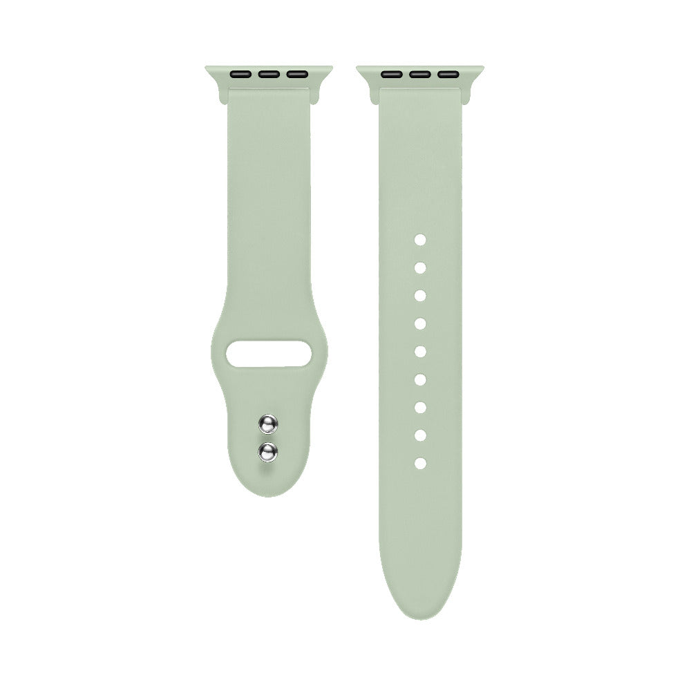 Sage green silicone Apple Watch® band close-up, detail view of molded texture and pin closure holes