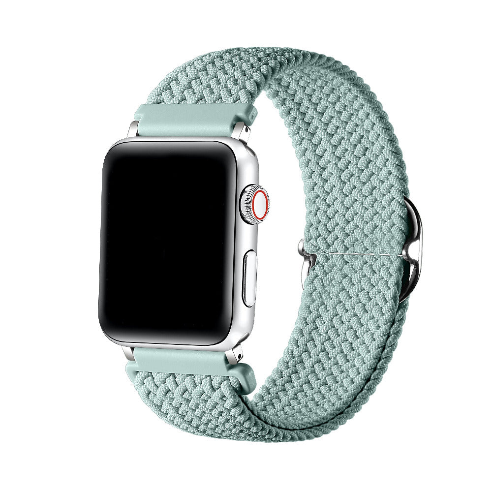 Sage Green braided nylon loop Apple Watch band worn on wrist, angled view showing adjustable buckle