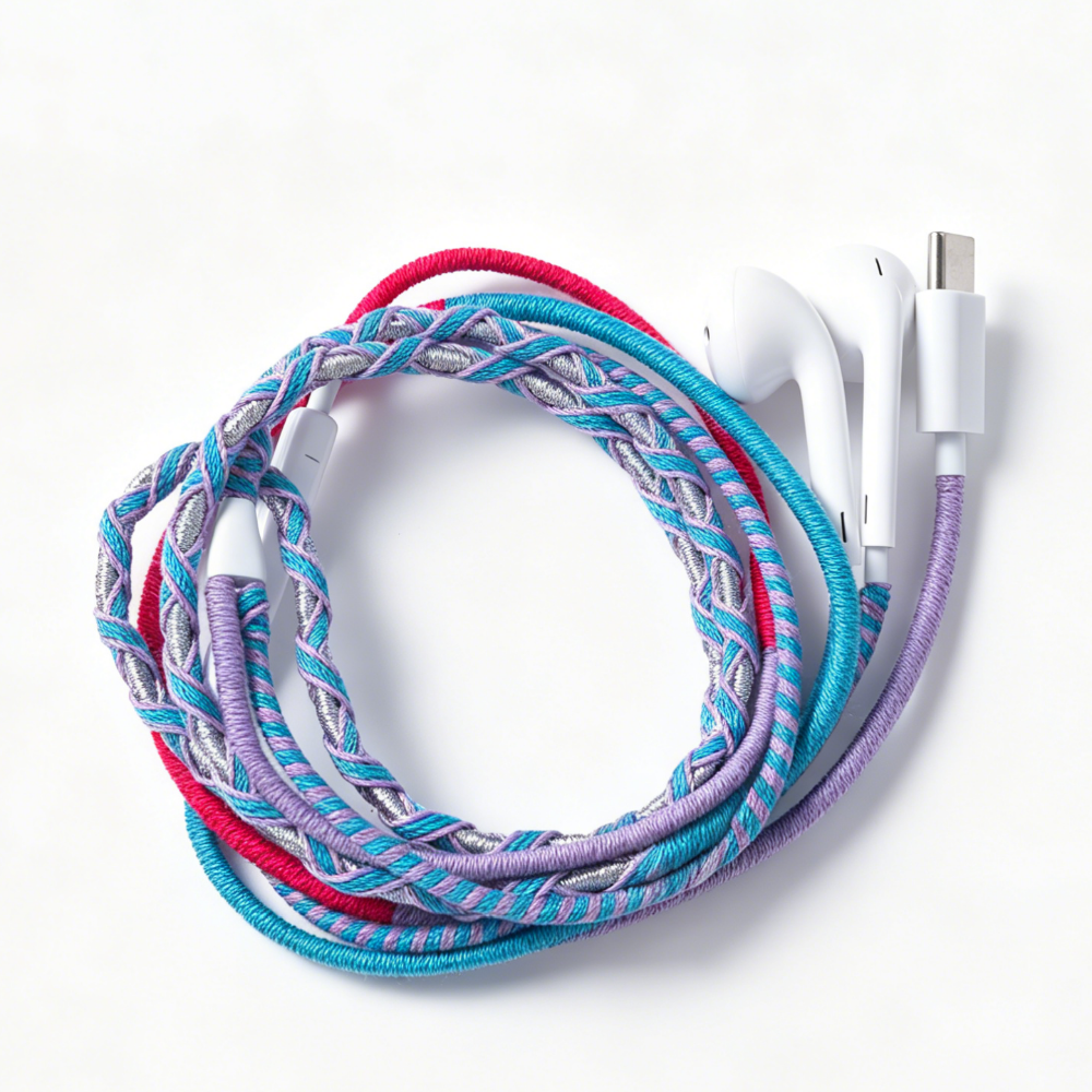 A braided multi-colored charging cable with white earbud-style connectors, coiled on a clean white background.