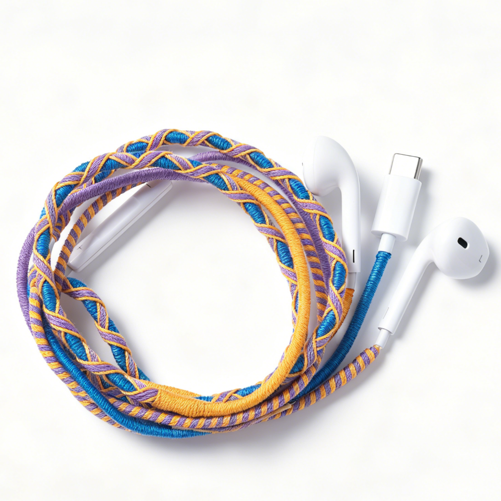 A braided multi-colored charging cable with white earbud-style connectors, coiled on a clean white background.