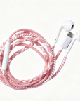 A braided multi-colored charging cable with white earbud-style connectors, coiled on a clean white background.