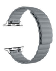 A light gray silicone watch band with a wavy, pleated design and silver metal connectors, shown on a plain white background.