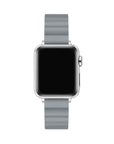 A silver smartwatch with a rectangular black screen and a light gray silicone strap, shown against a plain white background.