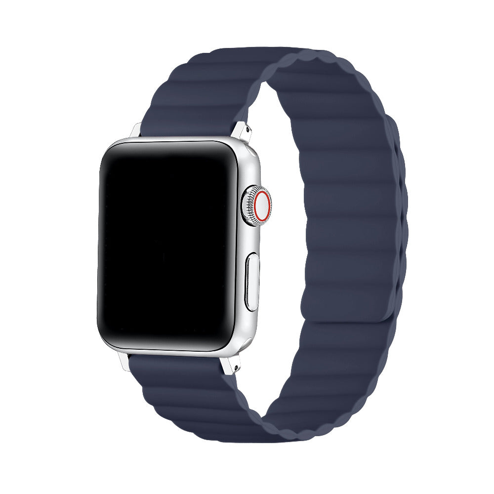 A silver smartwatch with a dark navy blue silicone strap featuring a wavy, ribbed texture, shown on a solid white background.