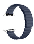 A dark navy blue silicone watch band with a textured, wavy segmented design and silver metal connectors, shown on a plain white background.